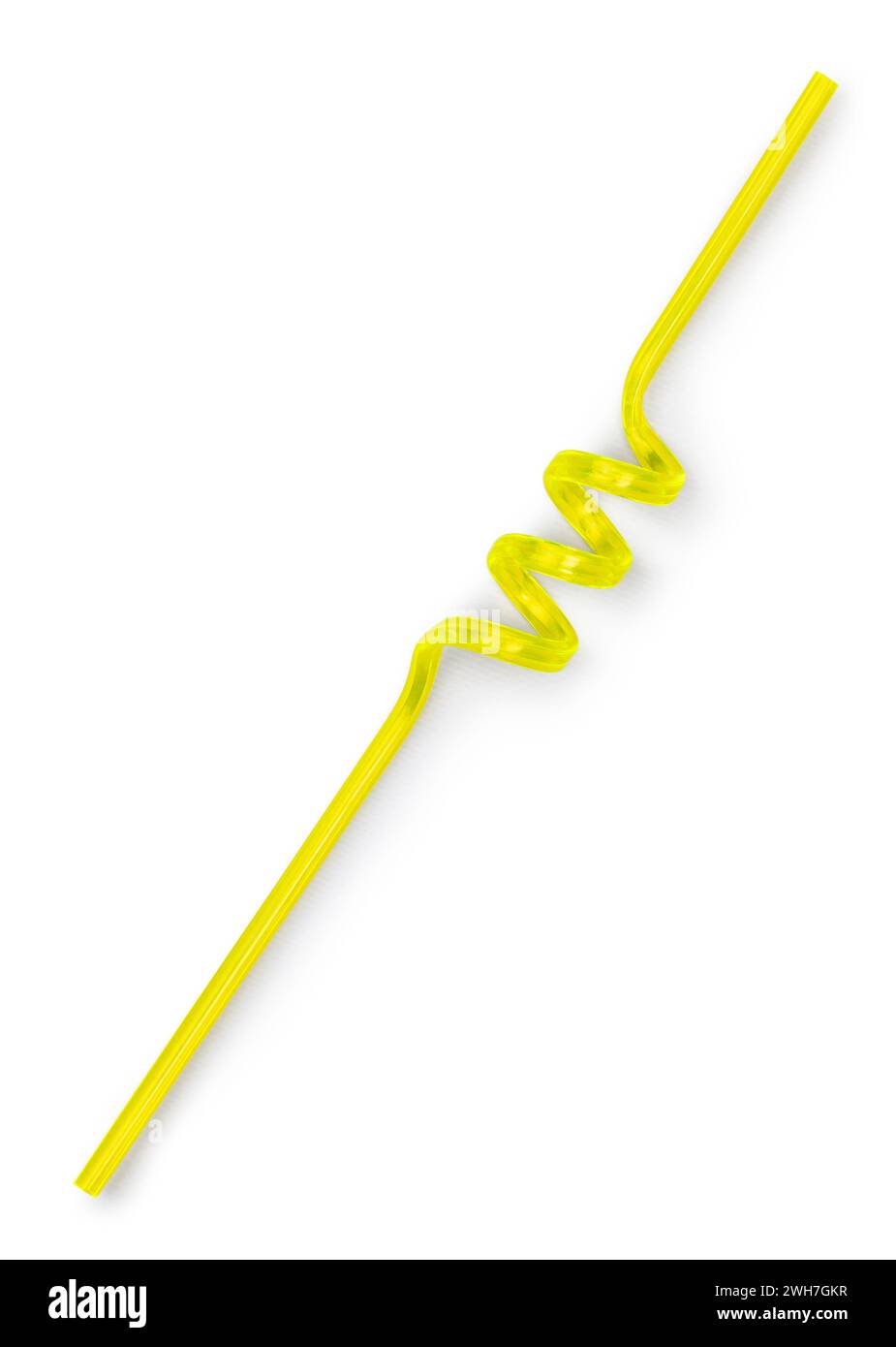 Yellow unused curly straw, top view. Isolated on a white background. Stock Photo