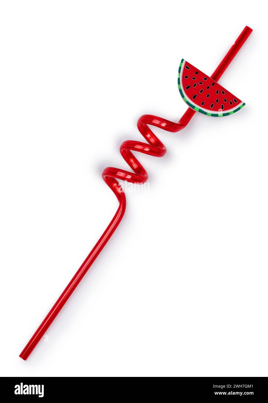 Red unused curly straw, top view. Isolated on a white background. Decorated with slice of watermelon. Stock Photo