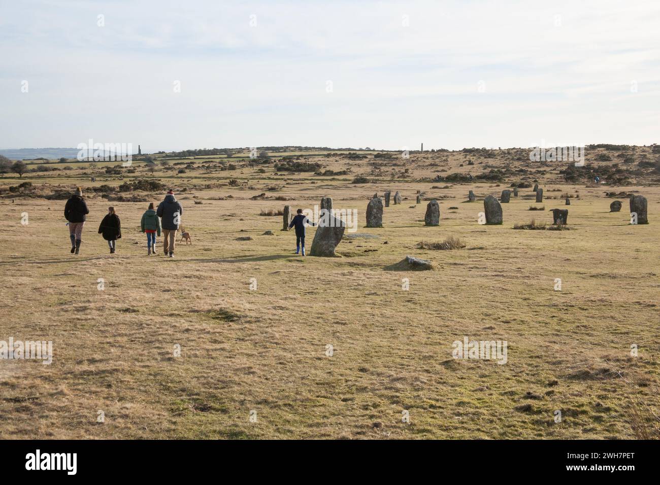 A family walks past the Hurler's Stones on Bodmin Moor, Cornwall in the UK Stock Photo