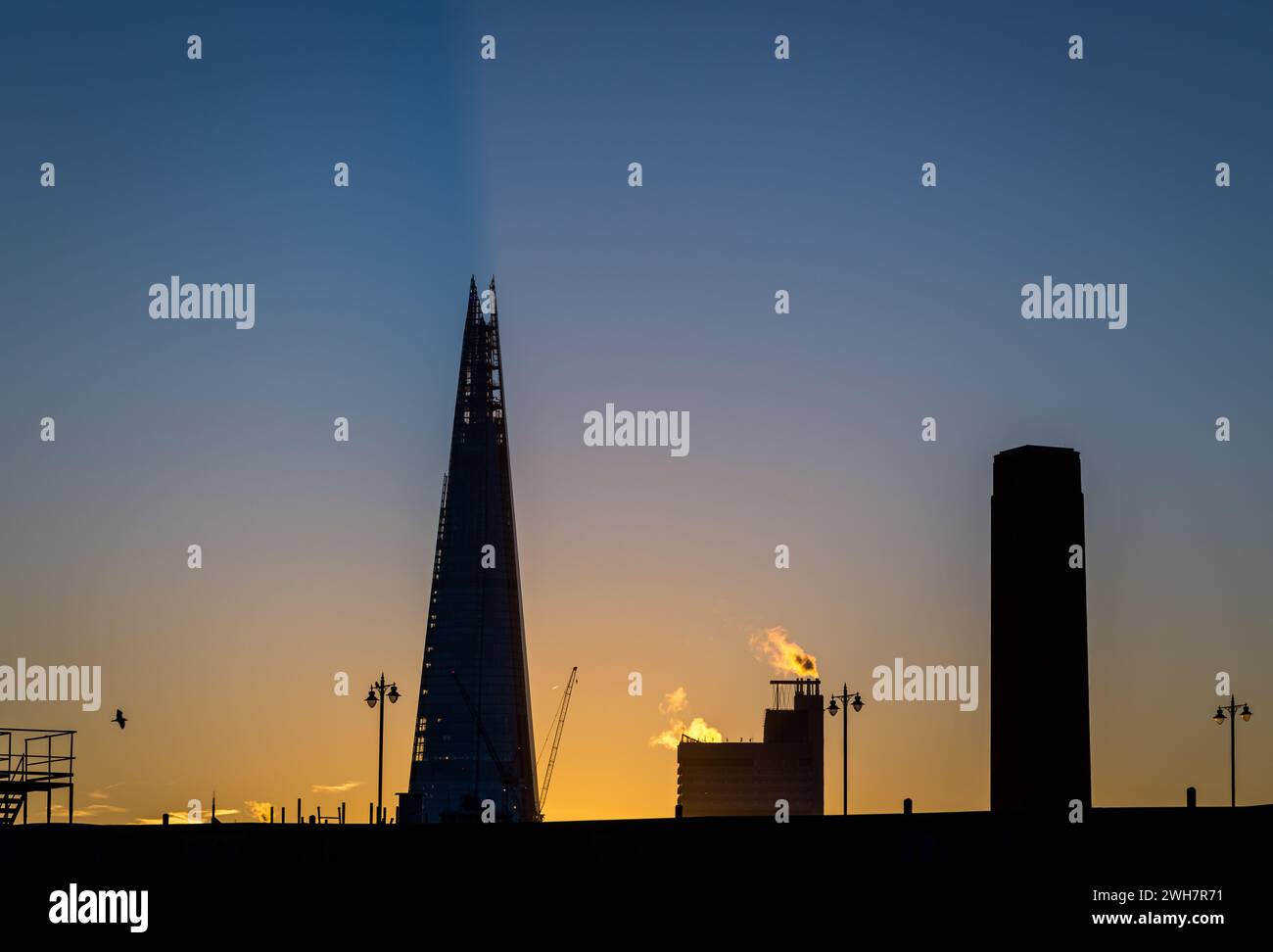 A striking image of the Shard with strong back lighting in early morning warm sun Stock Photo