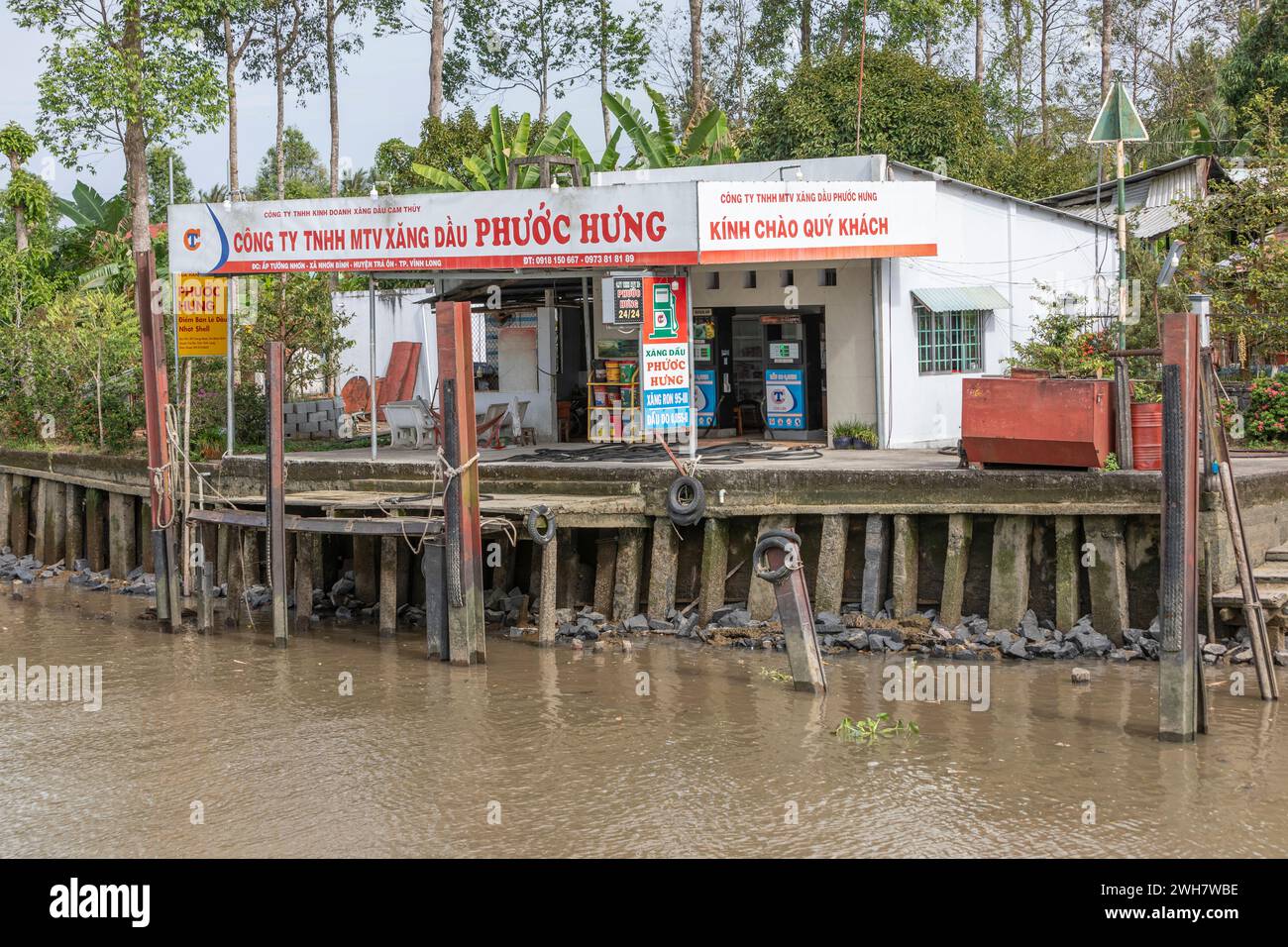 A small fuel station for boats on the banks of the Mekong Delta, Vinh Long, Vietnam Stock Photo