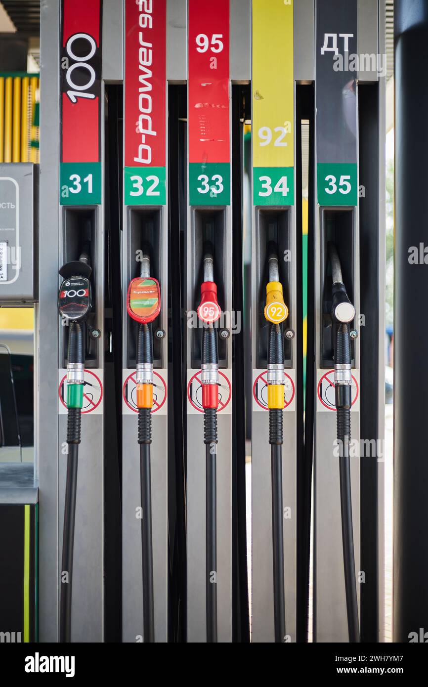 Gas pump at a gas station. Car refueling. Gasoline dispensers, fuel nozzle unit, refueling gun 95 92 b power 100 petrol and diesel fuel, benzine hose. Stock Photo
