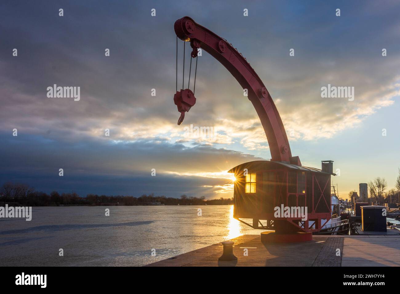 river Donau Danube at sunrise, old port crane, jetty Handelskai Vienna 02. Leopoldstadt Wien Austria Stock Photo