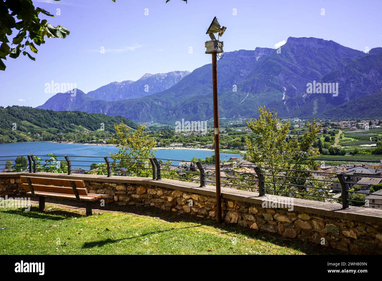 the tranquility of the view of a lake and mountains sitting on a bench Stock Photo