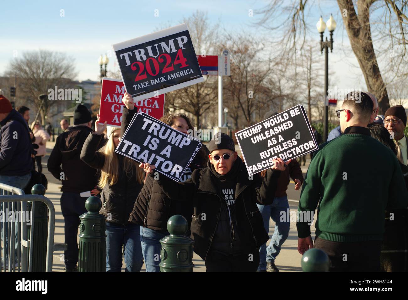 Washington, DC, USA. 8 Feb 2024. Protesters hold competing signs outside the Supreme Court as the court hears arguments regarding Colorado's decision to remove former president Donald Trump from the ballot. Credit: Philip Yabut/Alamy Live News Stock Photo