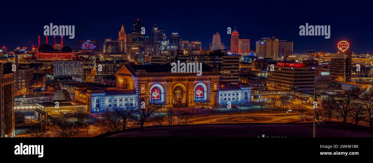 Nighttime city skyline illuminated by building lights Stock Photo