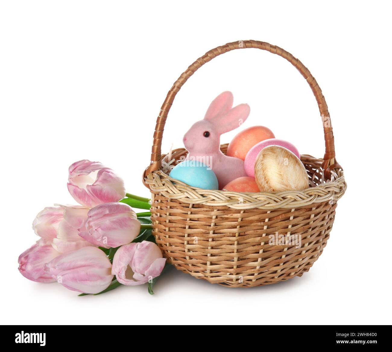 Basket with painted Easter eggs, bunny and pink tulips on white ...