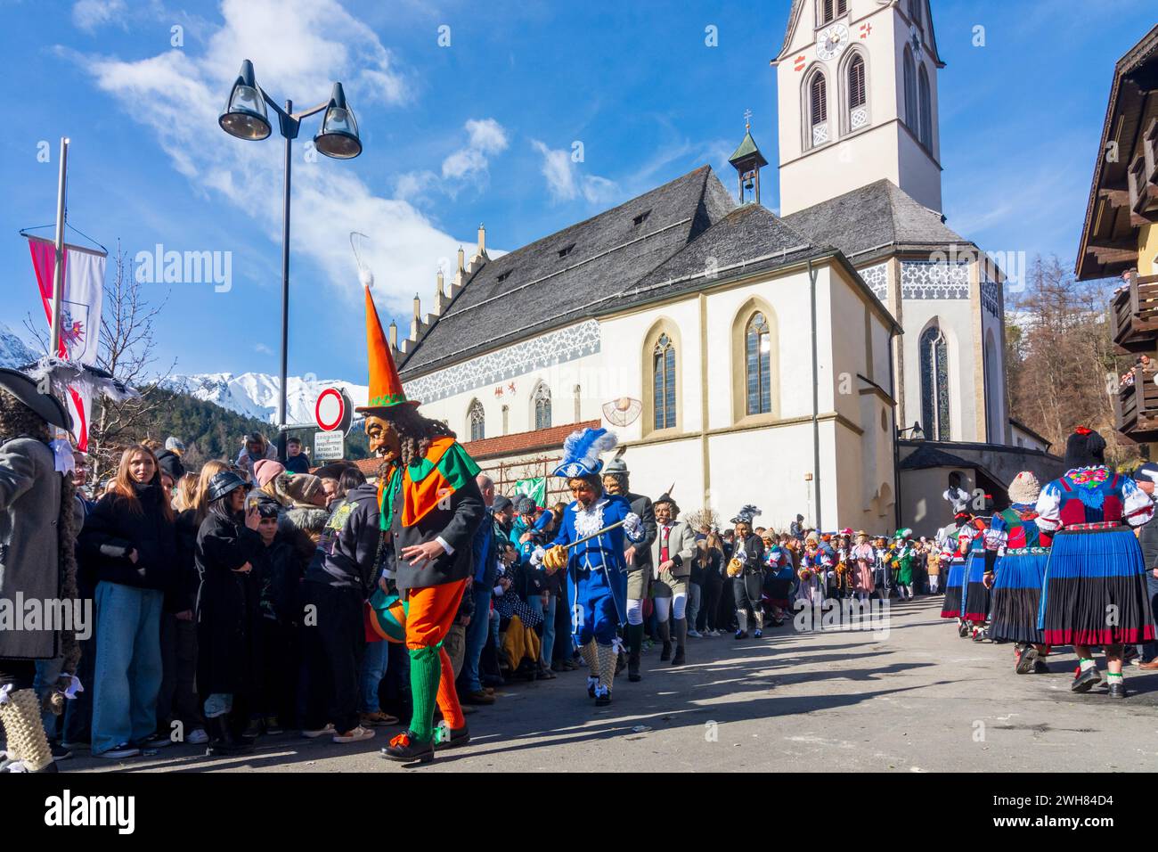 Imster Schemenlaufen (carnival), church Imst in background Stock Photo