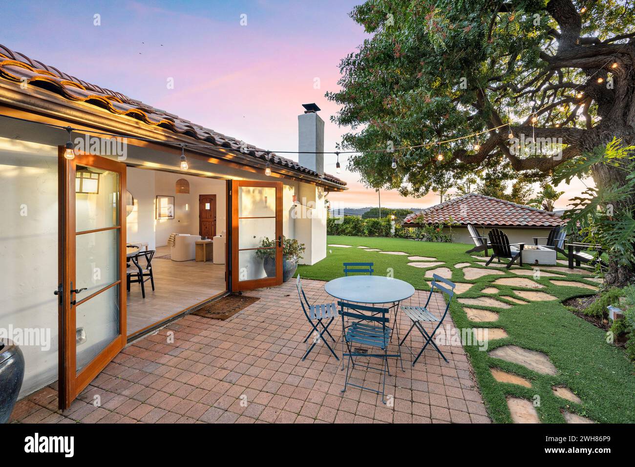 Outdoor patio with table and chairs in front of a house Stock Photo - Alamy