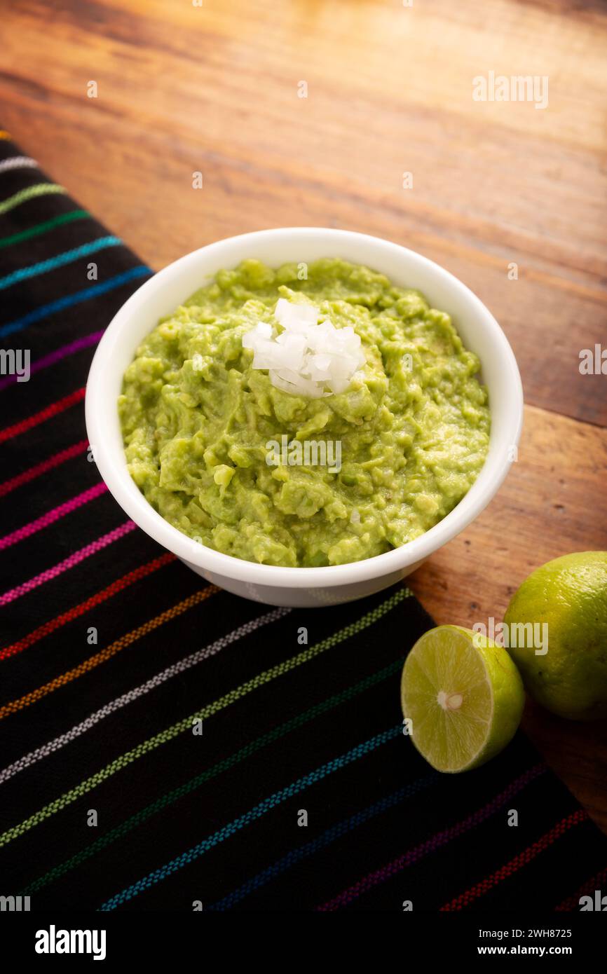 Guacamole. Avocado dip sauce, one of its many ways of consuming it is spread on tortilla chips also called Nachos. Mexican easy homemade sauce recipe Stock Photo