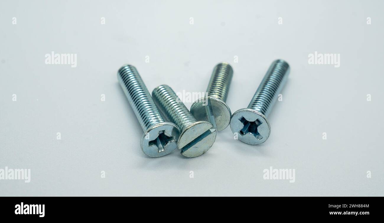 Four hexagonal bolts arranged on a white background Stock Photo