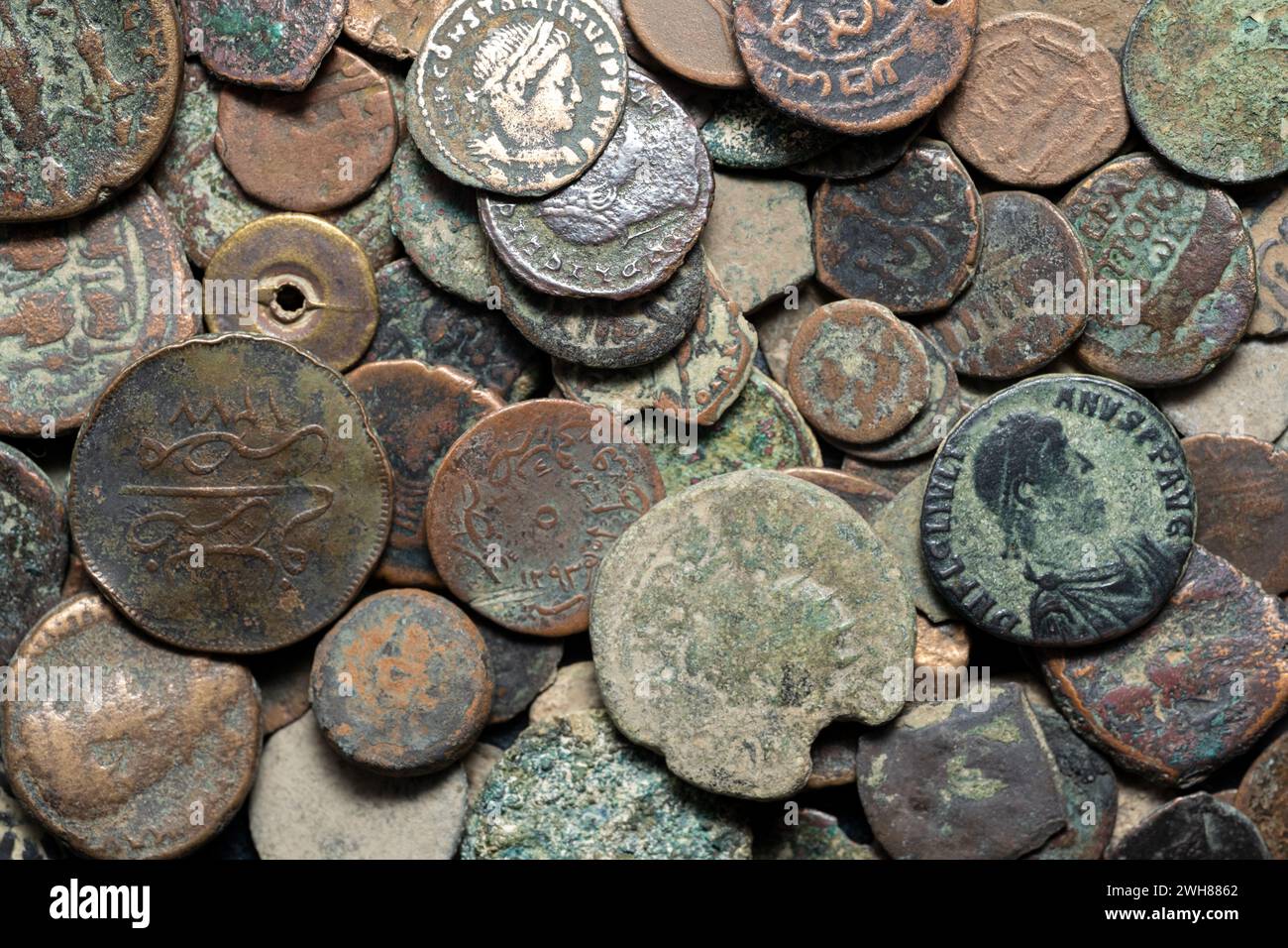 A collection of antique coins, relics, historical artifacts of the past from bygone eras. Stock Photo