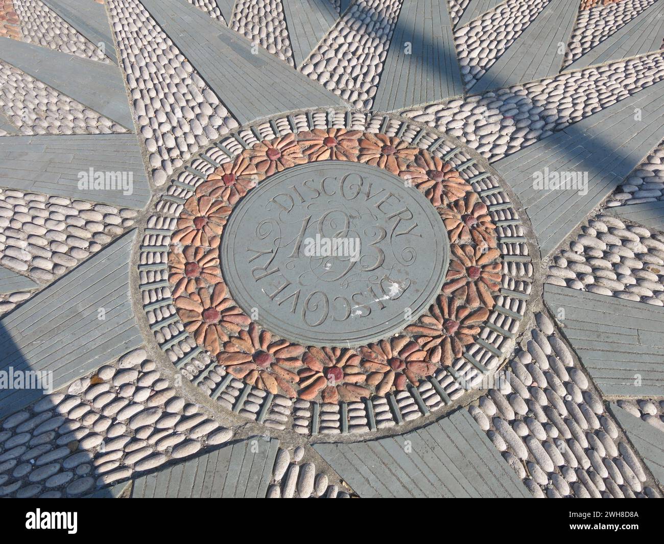 Close-up of the decorative mosaic pavement with a pattern of cobbled stones in the shape of a compass with the name Discovery; Dundee's RSS Discovery. Stock Photo