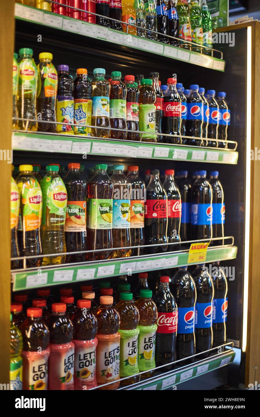 Plastic bottles of soda and cold tea different brands. Coca Cola, Pepsi, Lipton, Fuze. Store shelf, large selection, Beverage editorial, popular carbo Stock Photo