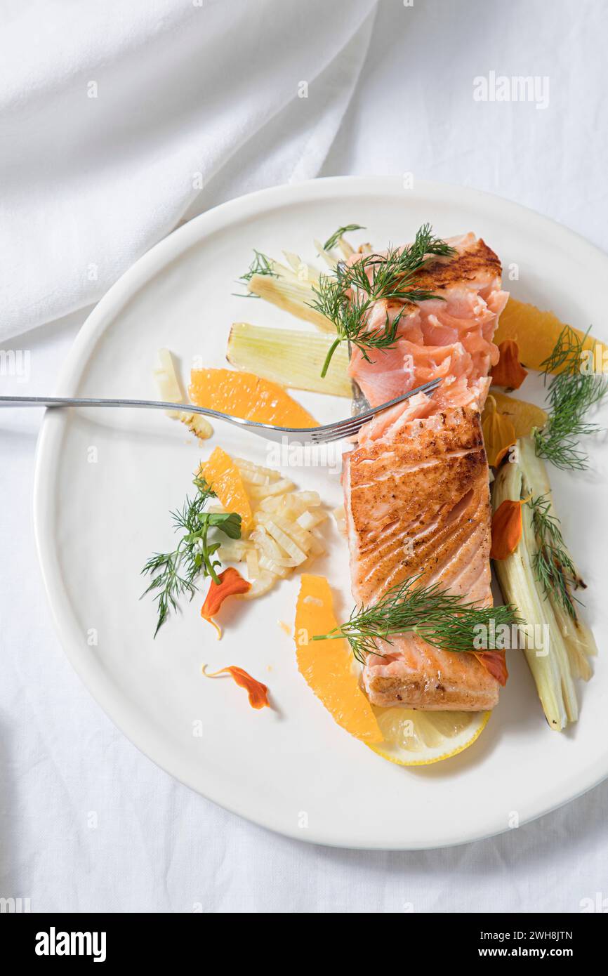 Sliced salmon fish steak on a plate of vegetables Stock Photo