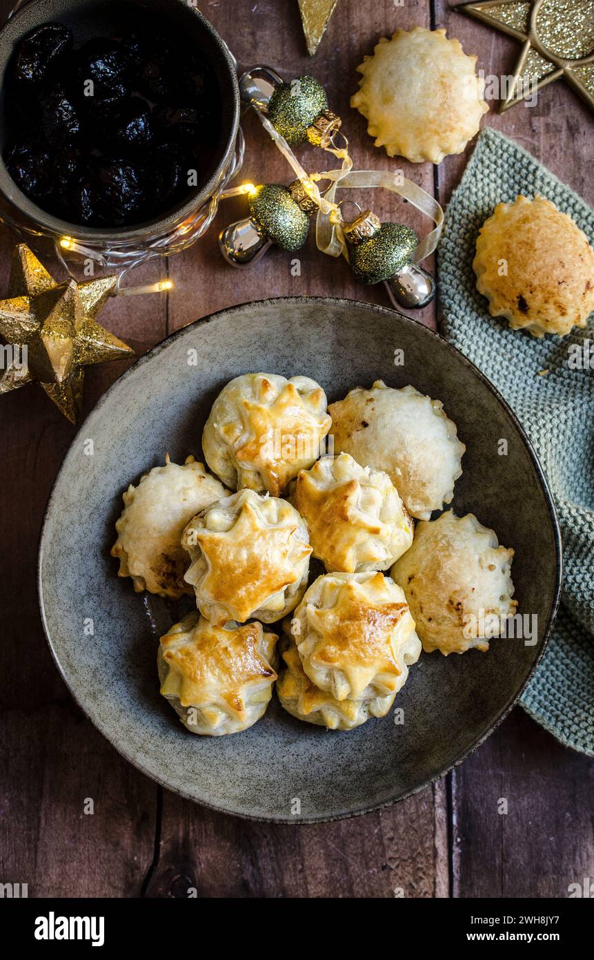 Puff Pastry apetizers with dried plum and italian ham, called Speck. Stock Photo