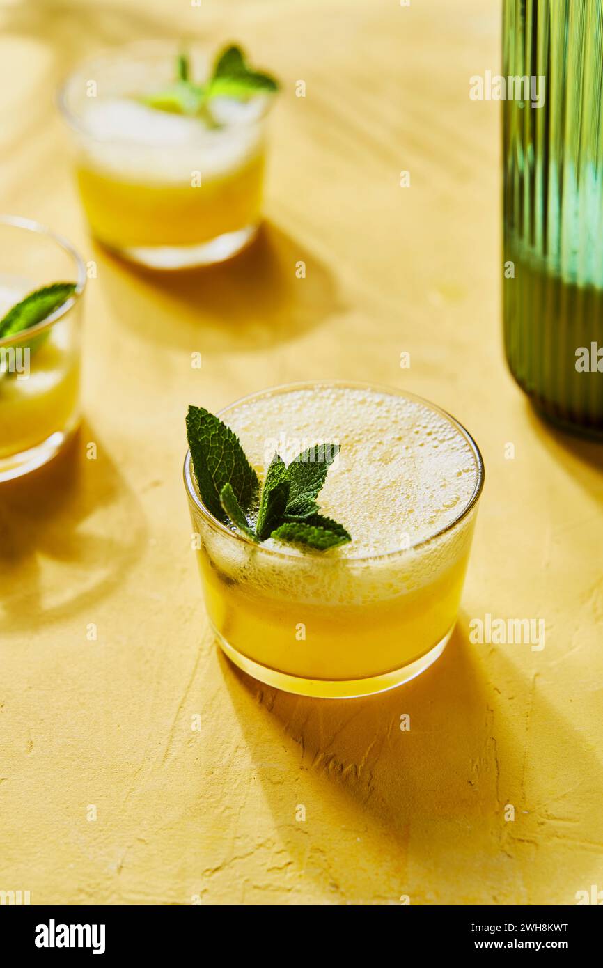 Pineapple Mint G&Ts with pourer on Yellow Background with Shadow Stock Photo