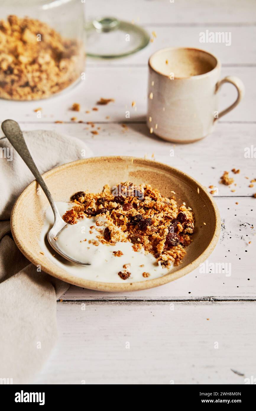 Granola with Yogurt on a Light Wooden Table with Coffee and napkin Stock Photo