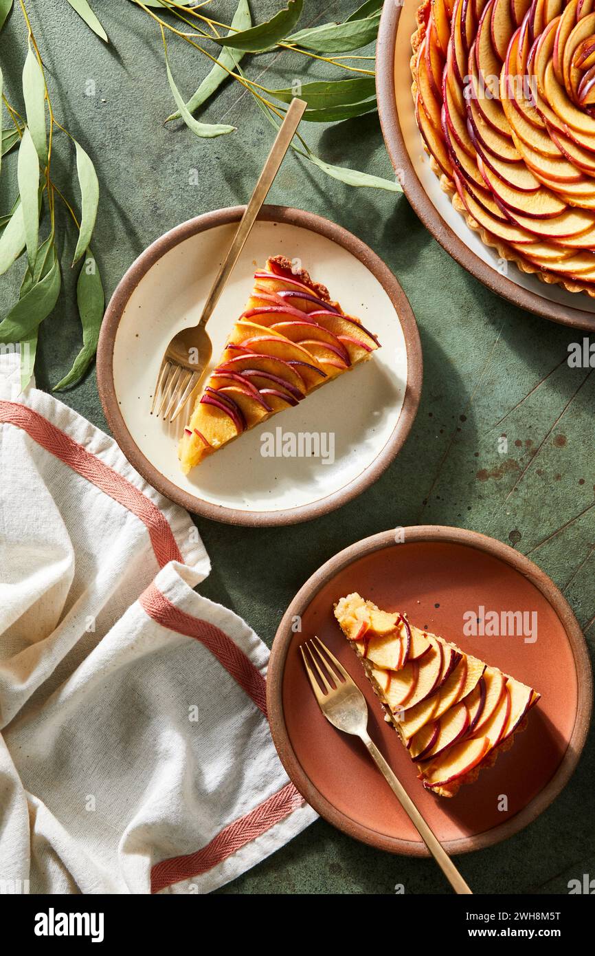 French Apple Tart with layered apples on a green background Stock Photo
