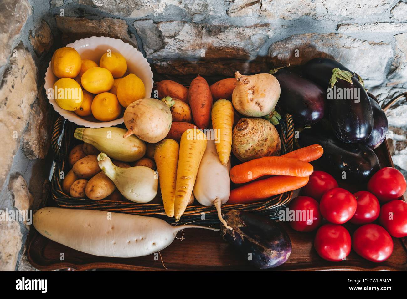Fresh fruit and vegetables displayed on a wooden surface Stock Photo