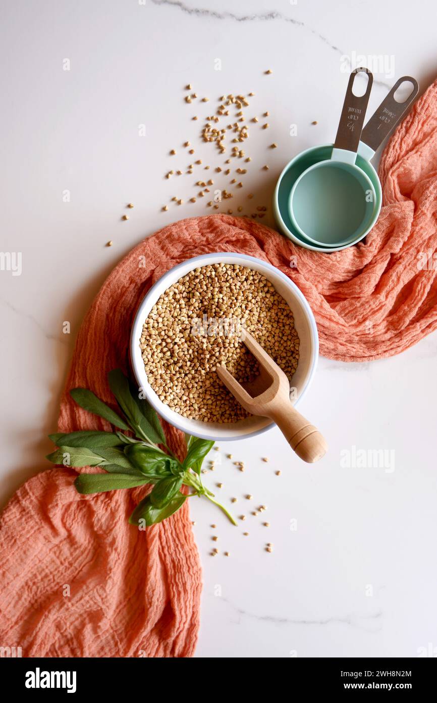 Buckwheat groats ingredient cooking and baking concept on white marble