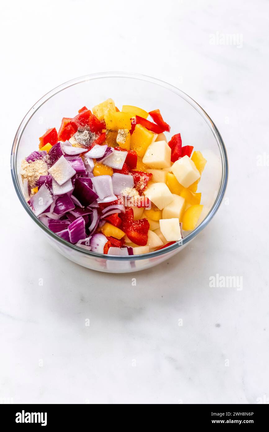 roasted potatoes, peppers and onions in a bowl Stock Photo