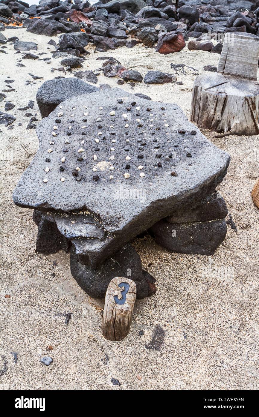 Hawaiian strategy game of Konane played with pebbles on a lava stone surface, at Pu'uhonua o Honaunau National Historical Park, Hawaii. Stock Photo