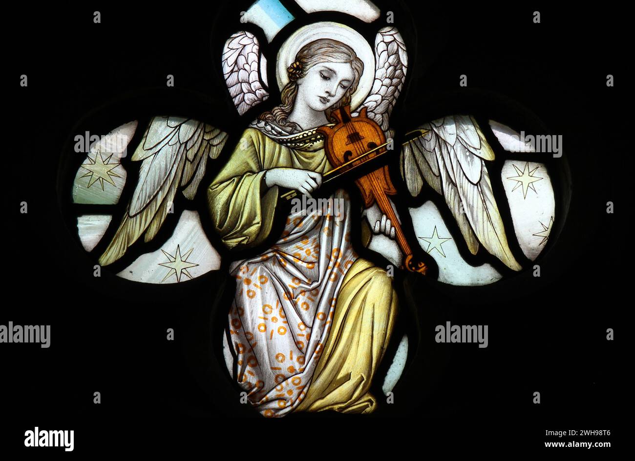 Stained glass panel of angel playing music Stock Photo