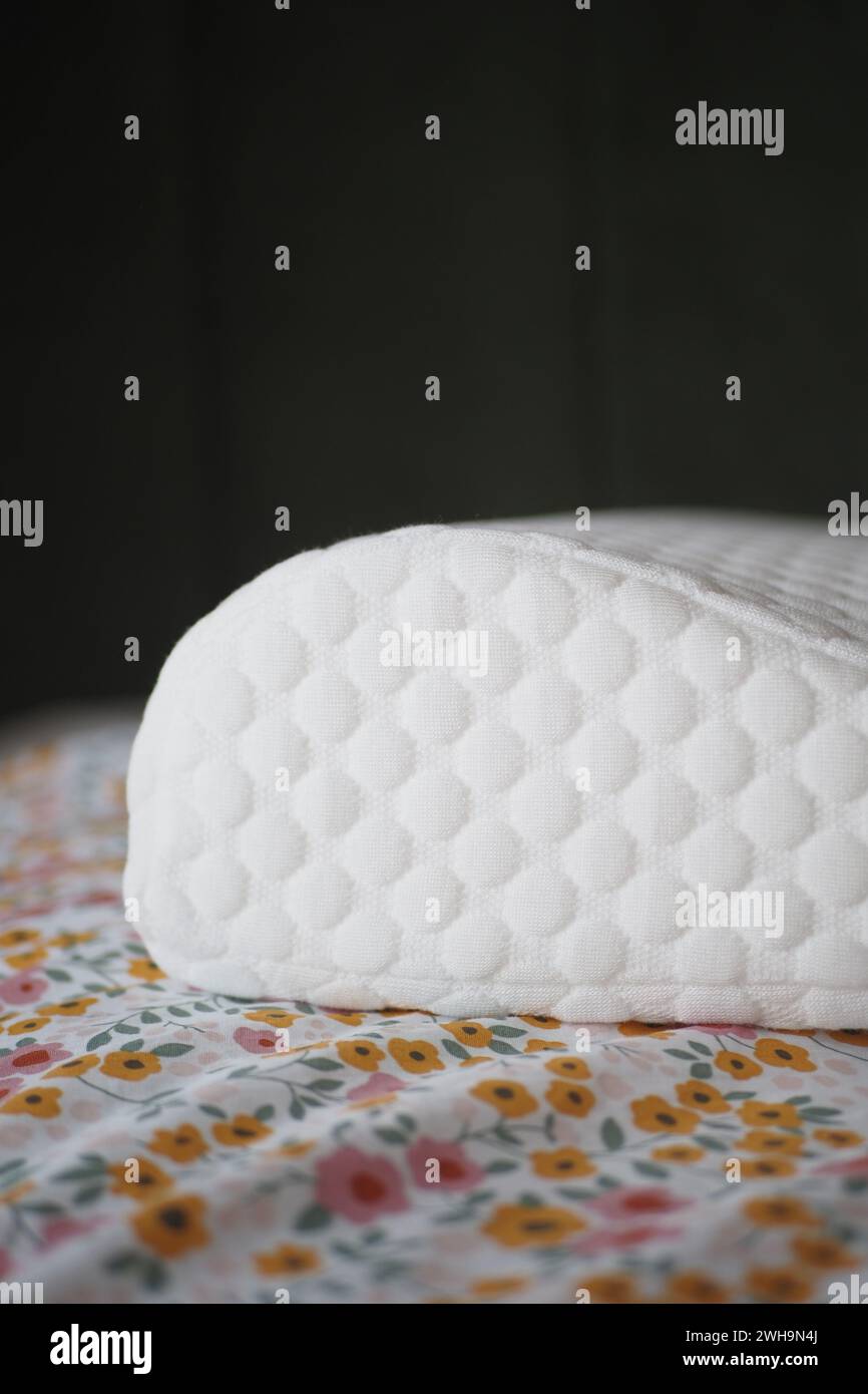 Orthopedic memory foam pillow on bed  Stock Photo