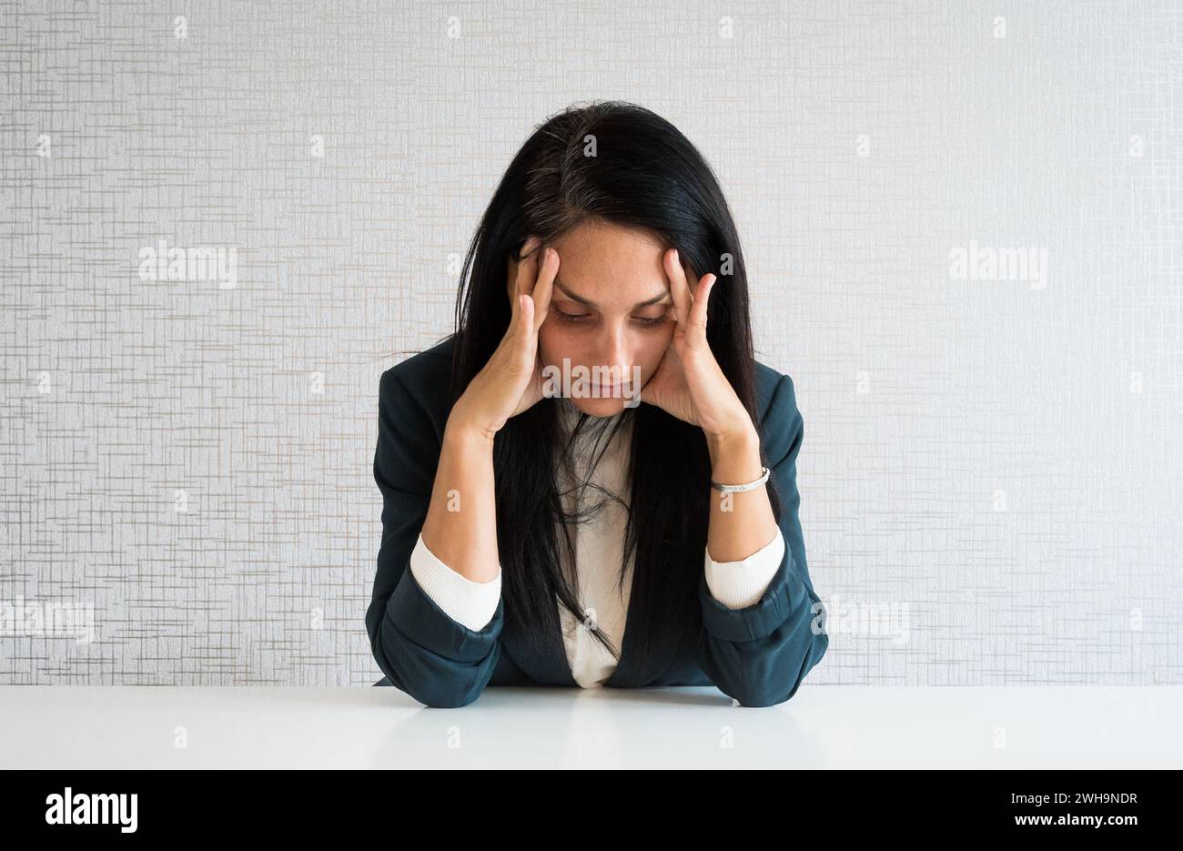 Caucasian woman employee in office at work tired worried over work hold ...