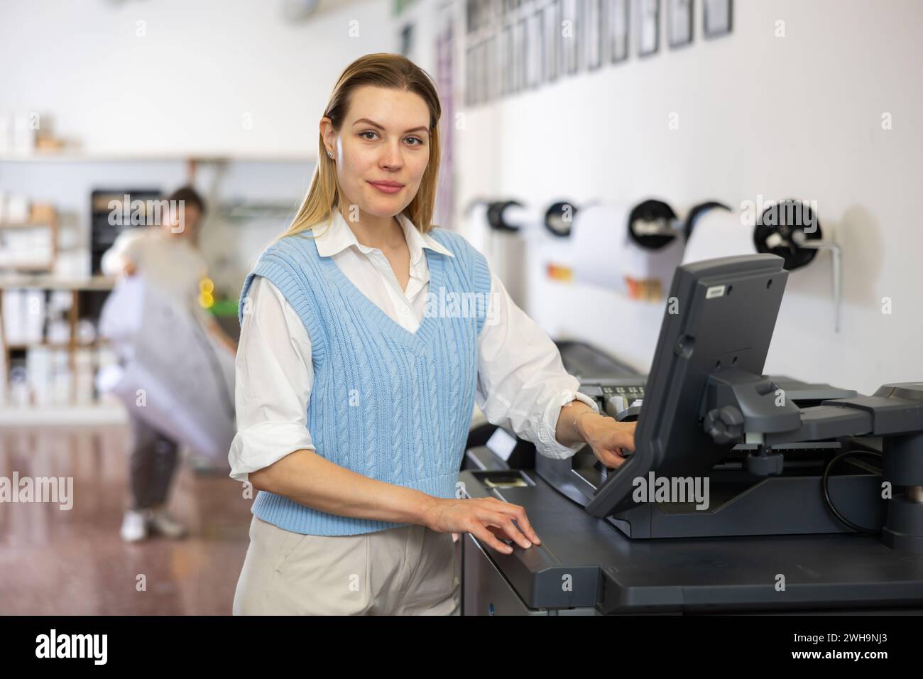 Technician operator calibrating plotter machine, typing on computer keyboard Stock Photo