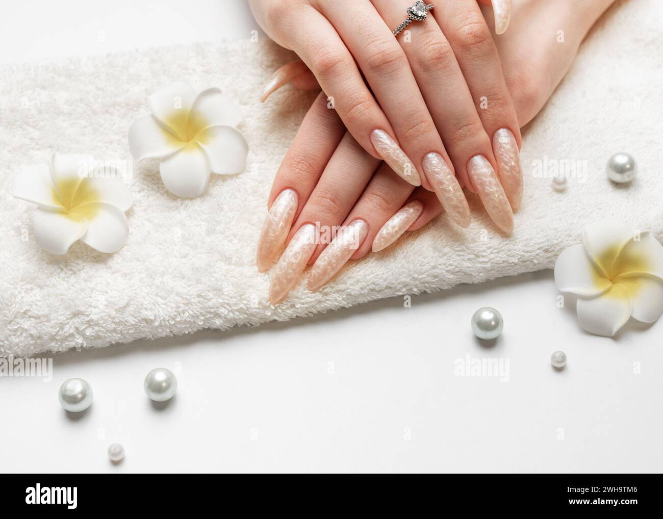 Manicured nails with pearlescent nail polish. Stock Photo