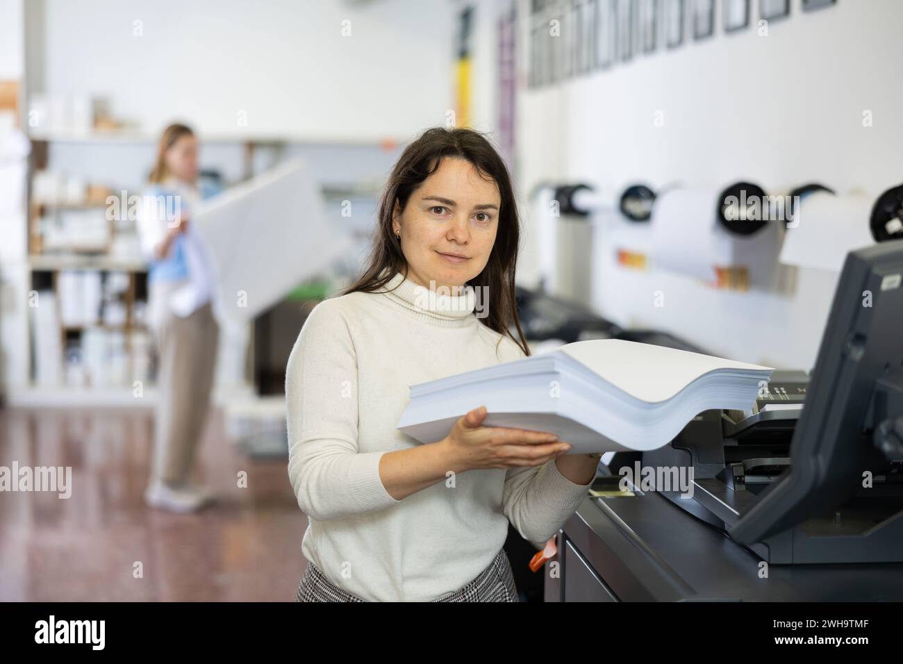 Technician working on plotter and cutter machine in printing shop Stock Photo