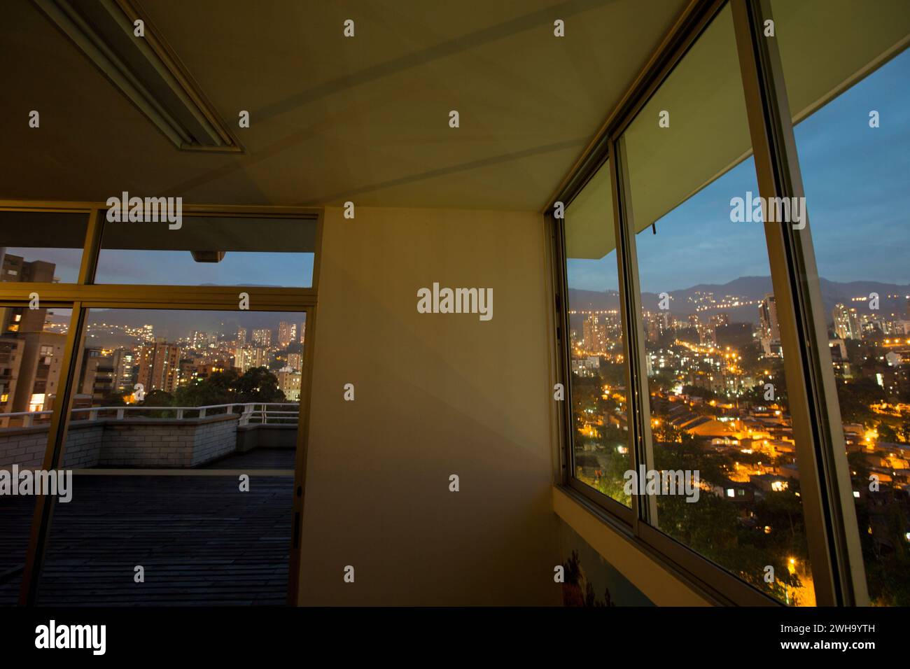 A rooftop terrace in Medellin that overlooks the city at night with ...