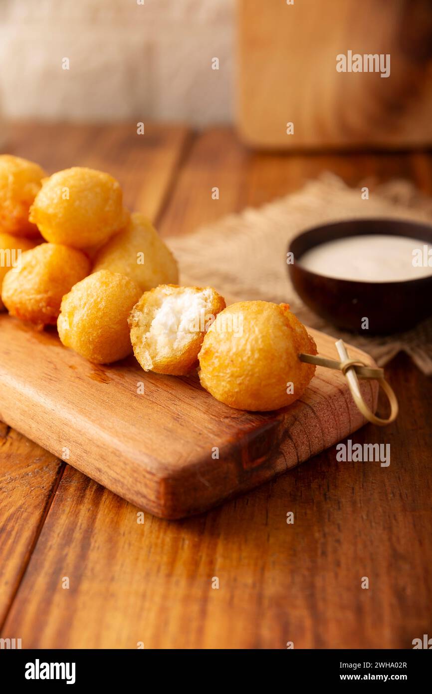 Fried breaded cheese balls, easy and delicious homemade snack recipe. Served with dipping sauce. Stock Photo