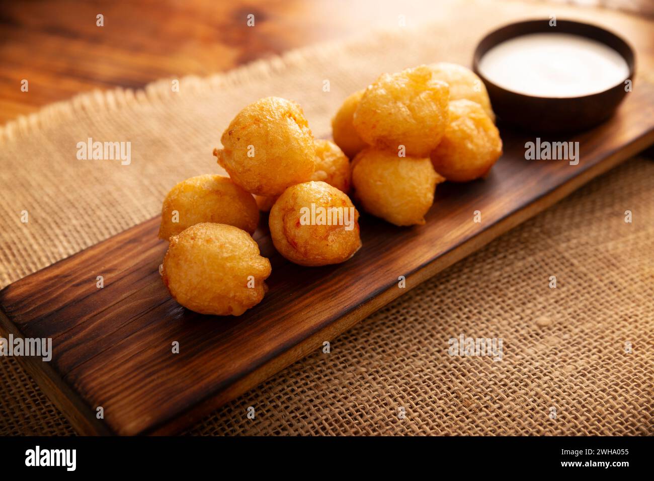 Fried breaded cheese balls, easy and delicious homemade snack recipe. Served with dipping sauce. Stock Photo