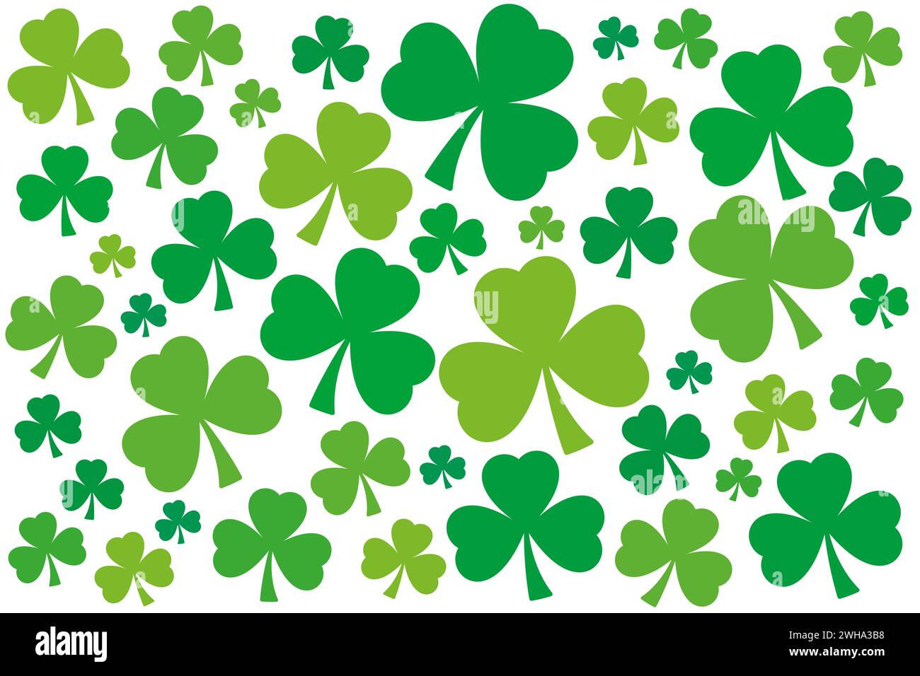 Numerous shamrocks, green three-leaf clover background. Randomly arranged, slightly twisted trefoils with different shades of green. Symbol of Ireland. Stock Photo