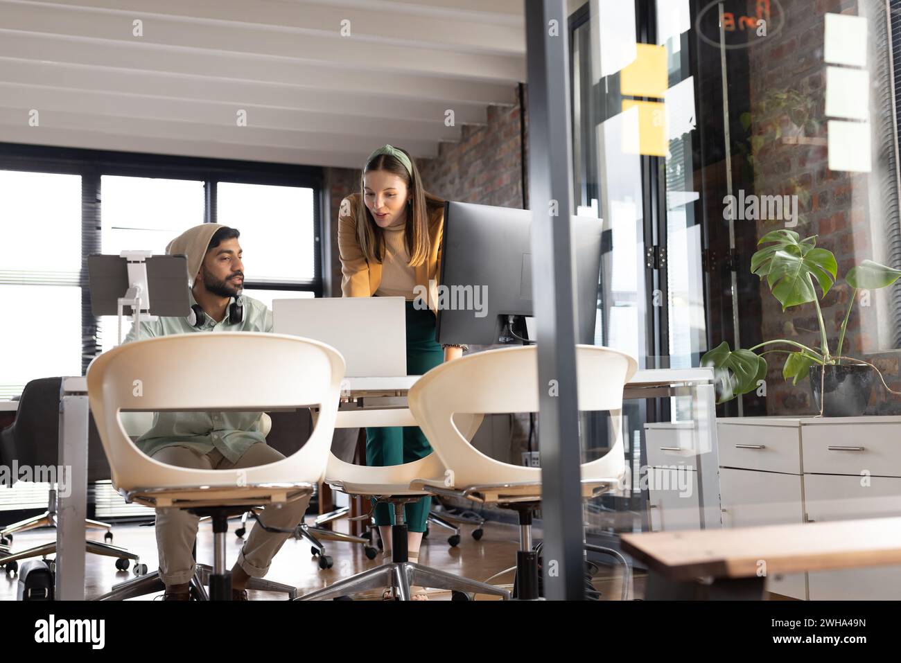 Diverse colleagues collaborate in a casual business setting in a modern office Stock Photo