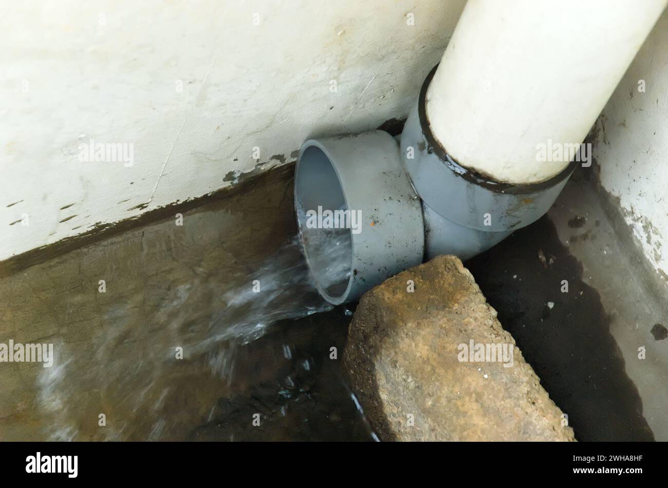 Rainwater drain pipe filled with rainwater Stock Photo