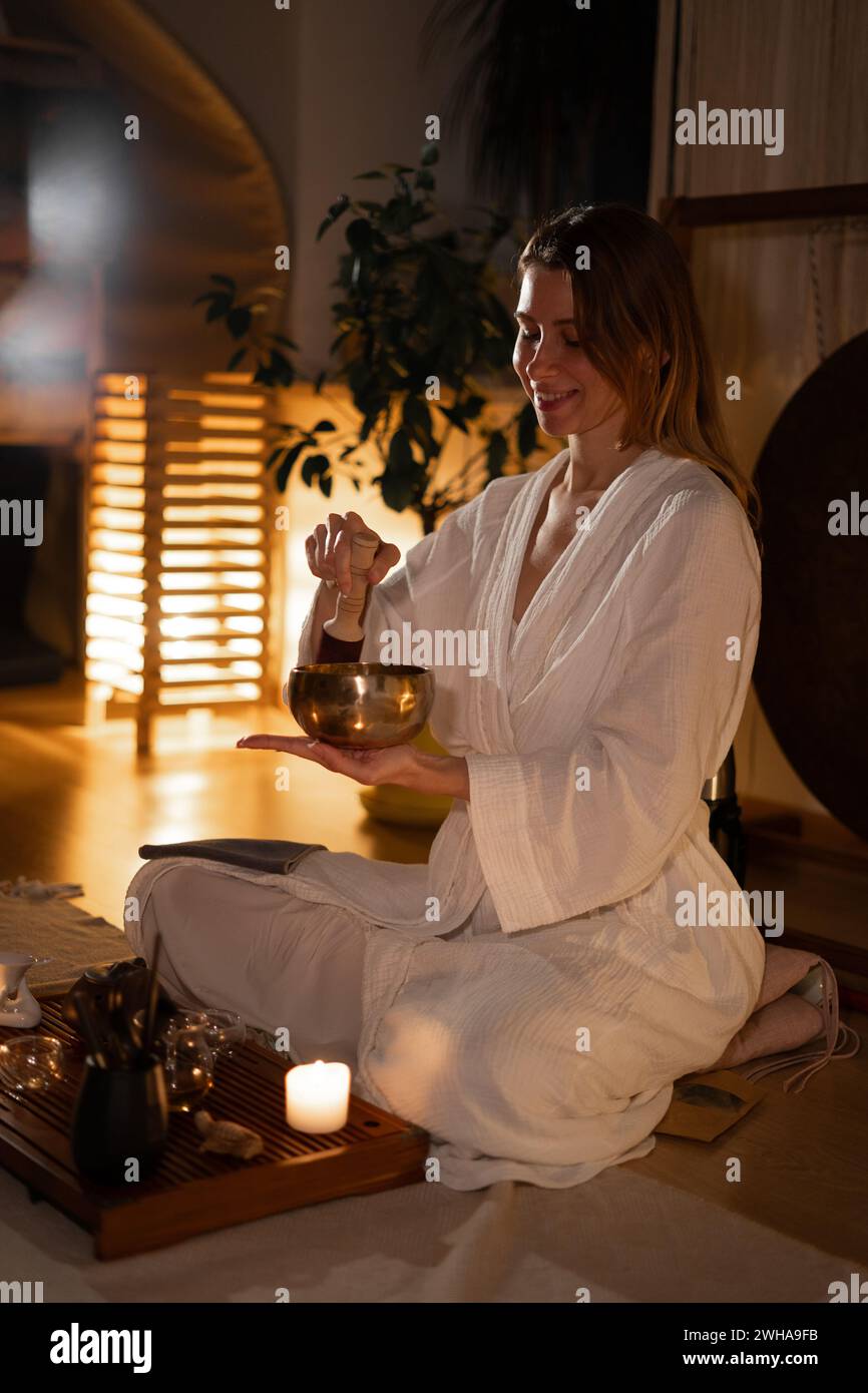 Beautiful woman playing tibetan bowl or singing bell at Japanese tea ceremony culture east beverage Stock Photo