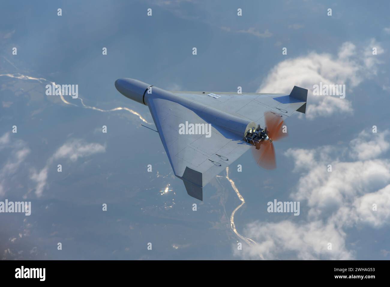 An aerial view of the Russian army's Shahid combat drone in the sky against a cloud backdrop, flying over the ground of the war in Ukraine, drone atta Stock Photo