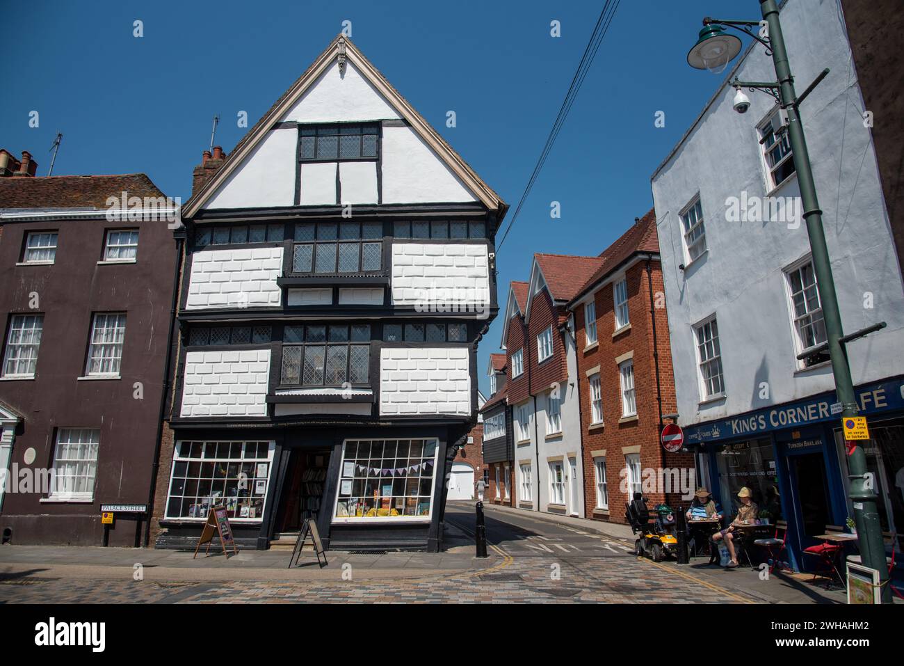 Bookshop in a crooked leaning house on canterbury palace street in a leaning traditional British building. Stock Photo