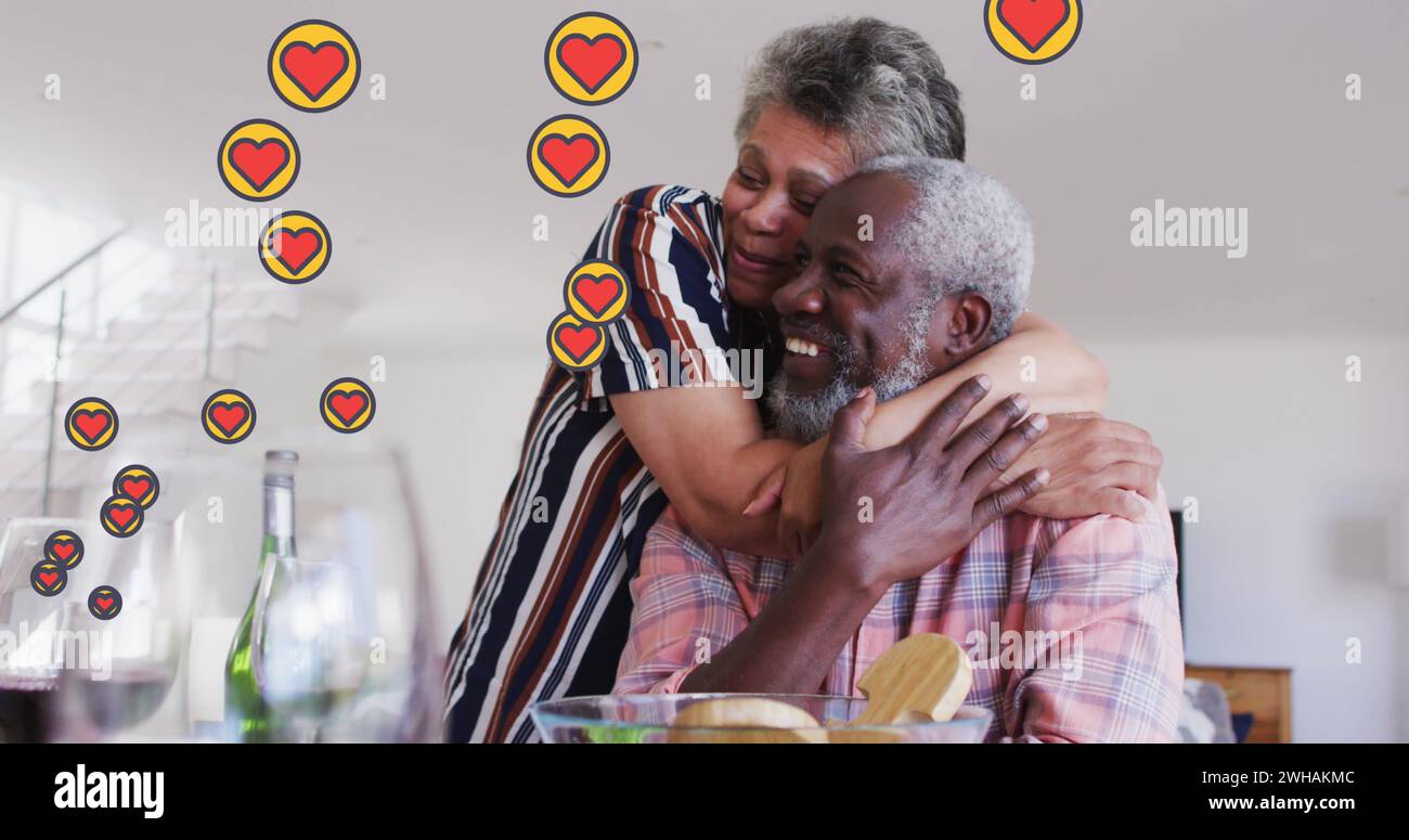 Image of hearts over senior african american couple embracing Stock Photo