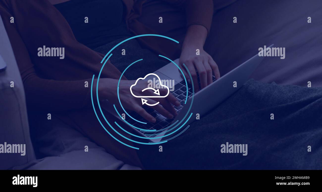 Image of cloud icon over hands using laptop in office Stock Photo
