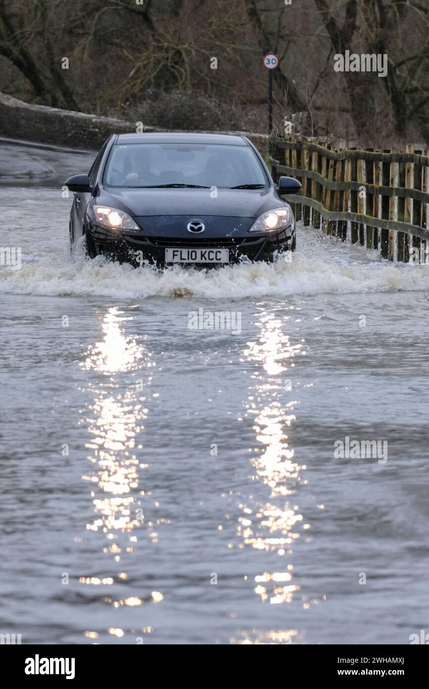 Lacock, Wiltshire, UK. 9th Feb, 2024. The River Avon in Lacock has burst its banks on flooded the road out of the village. Advice is not to drive through flood water but the road is passable with caution. Credit: JMF News/Alamy Live News Stock Photo