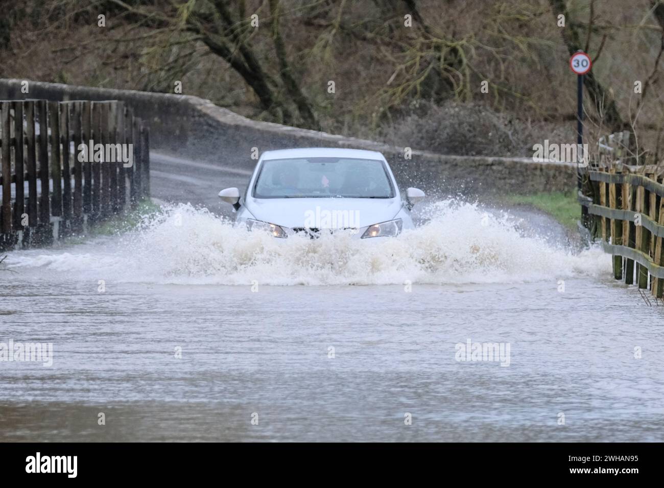 Lacock, Wiltshire, UK. 9th Feb, 2024. The River Avon in Lacock has burst its banks on flooded the road out of the village. Advice is not to drive through flood water but the road is passable with caution. Credit: JMF News/Alamy Live News Stock Photo