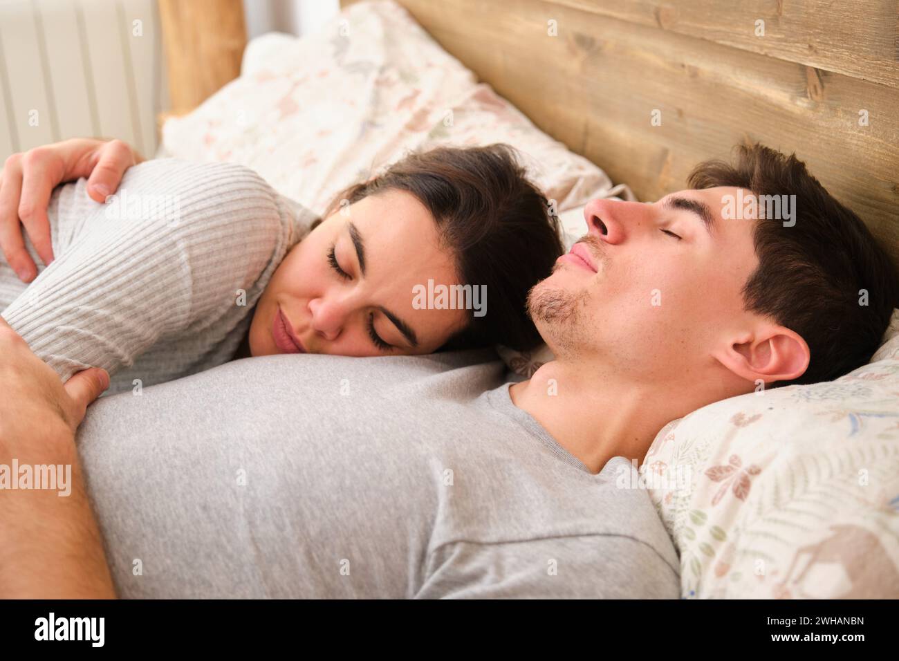 Spanish couple sleeping on bed in the morning. Stock Photo