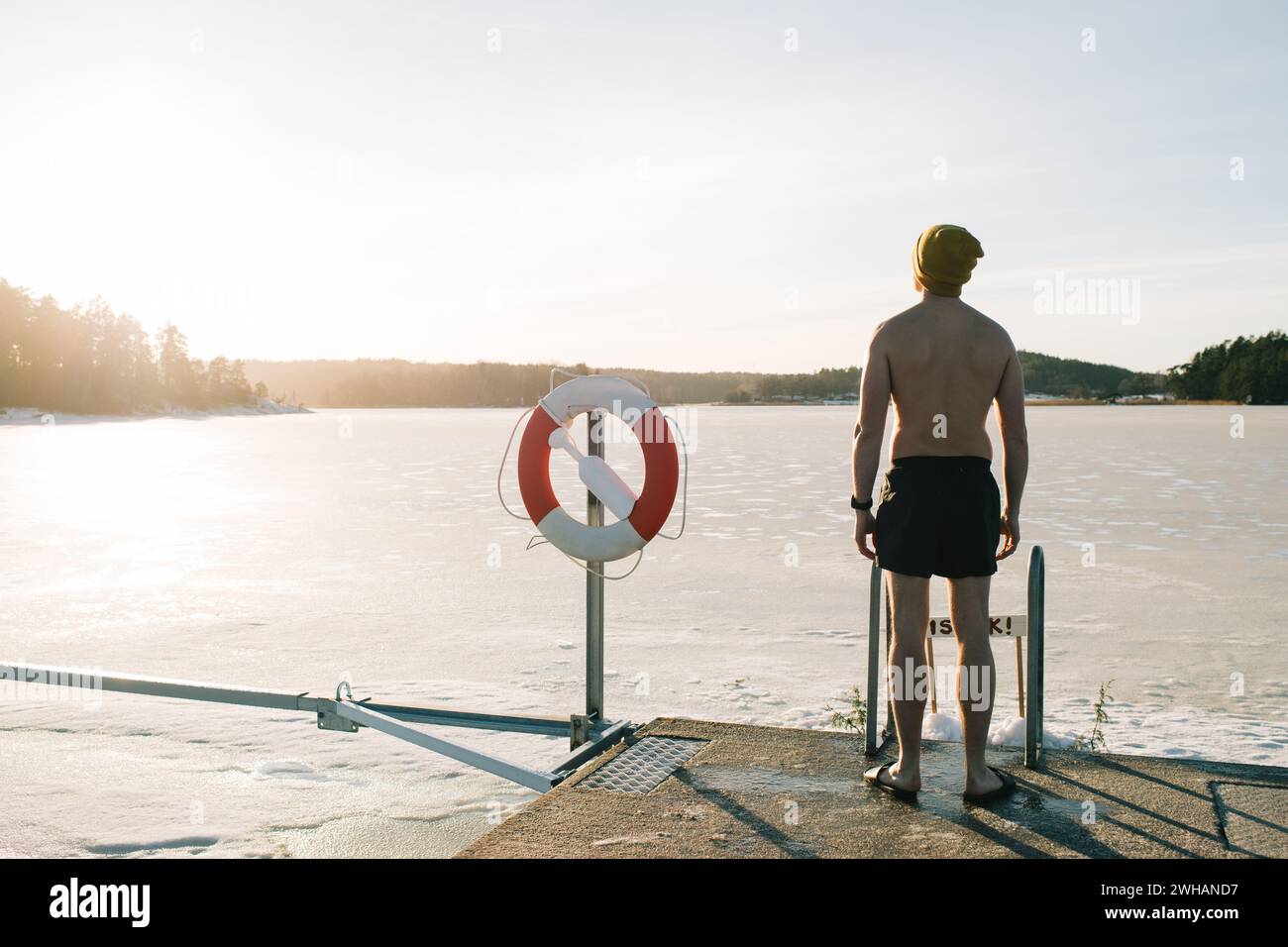 man standing getting some vitamin D before taking an ice bath Stock Photo