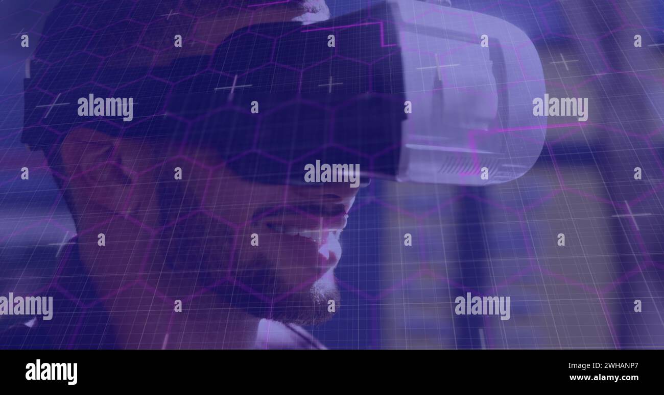 Image of purple light trails with hexagons over smiling man wearing vr ...