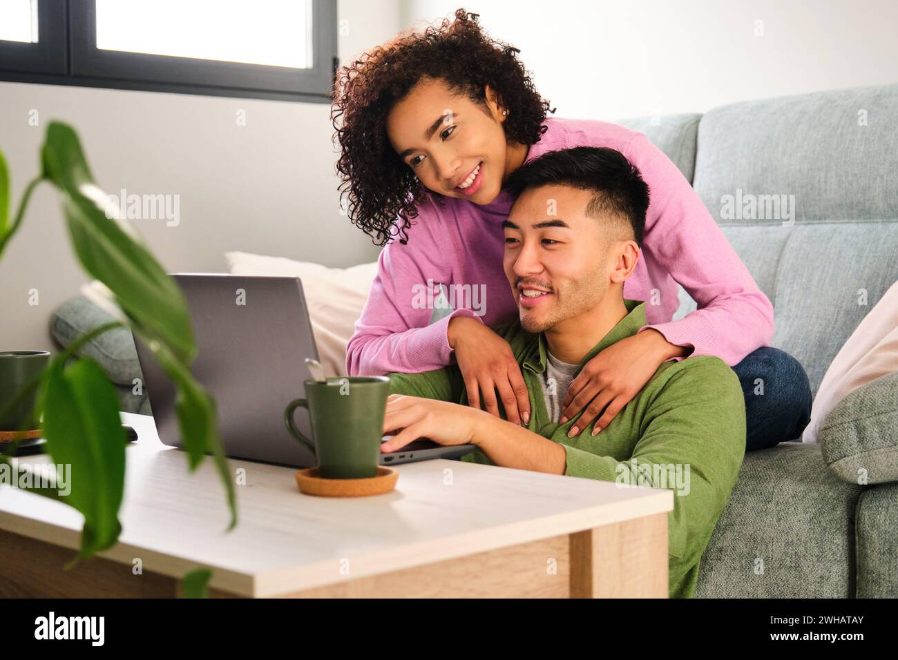 Asian couple sitting sofa using hi-res stock photography and images - Alamy